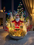 Lighted Santa Figurine Holiday Arrangement with Snowy Pine Trees, Red Berries, and Gold Foliage